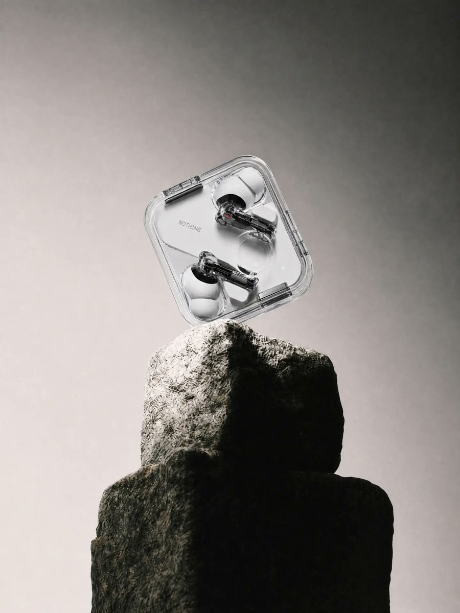 E-commerce Main Image - Transparent Earbuds on Stone Pedestal — output 1