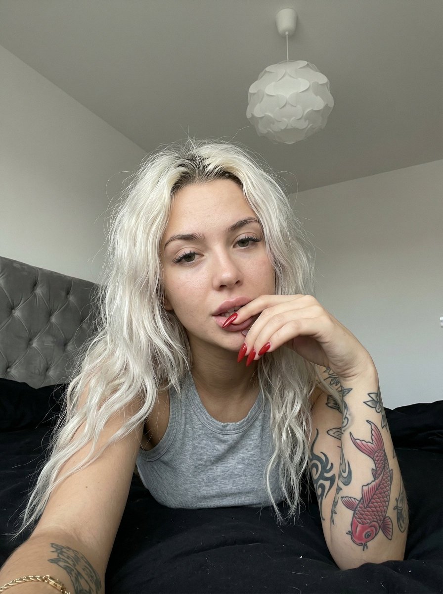 Profile / Avatar - Casual smartphone photo of a tattooed woman in a bedroom — output 1